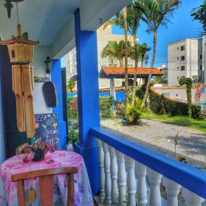 a balcony with a table and a view of a street at condominio colonial pousada mariscal in Canto Grande