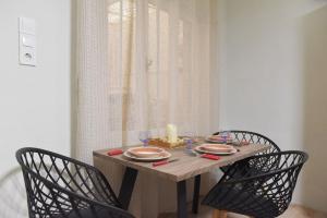 a table with two chairs and a candle on it at Nefeli House Syros in Ermoupoli