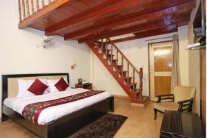 a bedroom with a bed and a stair case at Hotel Moon by Excellent Hospitality in Nainital