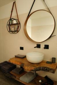 a bathroom with a sink and a mirror at DAL CARLETTO LUXURY APARTMENT in Riva del Garda +7 photos