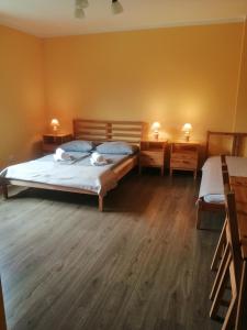 a bedroom with two beds and two night stands at Noclegi Na Smaguli in Korbielów