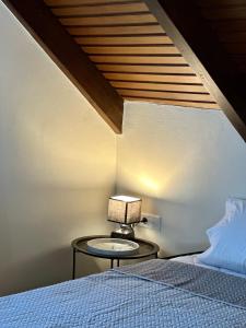 a lamp on a table next to a bed at Stavento Apartments in Argostoli