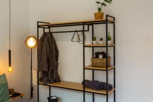 a shelf in a room with a coat and a coat at Sofia Downtown Boutique Apartment in Sofia