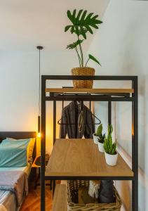 a shelf with potted plants on it next to a bed at Sofia Downtown Boutique Apartment in Sofia