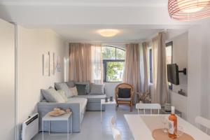 a living room with a couch and a table at Golden Aura in Danilia