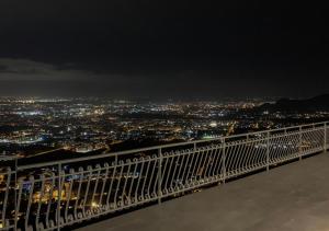 a view of a city at night from a balcony at Super panoramic new apartment in Casertavecchia in Caserta