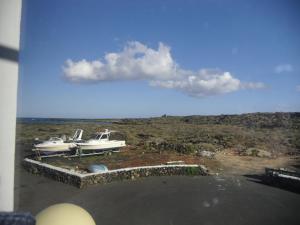 a view of two boats sitting on a dock at Tranquilo y Acogedor Apartamento in Órzola