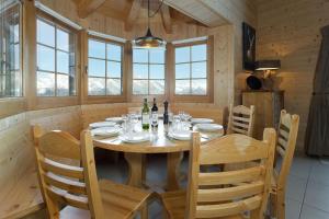 a wooden dining room with a table and chairs at Chalet Chocolat in La Tzoumaz