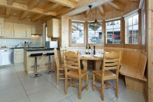 a kitchen with a table and chairs in a kitchen at Chalet Chocolat in La Tzoumaz