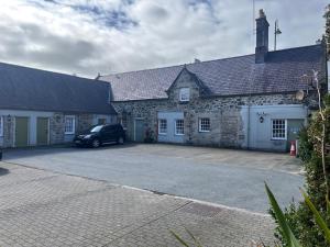 a car parked in front of a stone building at The Bull Hotel in Llangefni +9 photos
