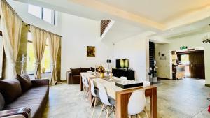 a living room with a table and a couch at Vila Mama Jana in Buşteni