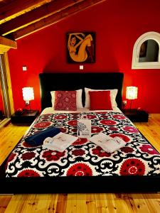 a bedroom with a bed with a red wall at Villa Mariza in Corfu Town