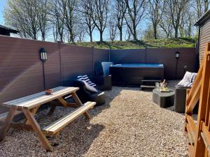 a patio with a wooden table and a bench at Stags Head Lodge in Felton