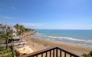 a view of the beach from the balcony of a condo at Apartamento con vistas frontales - Primera línea Playa Cargador - ALBERT VILLAS in Alcossebre