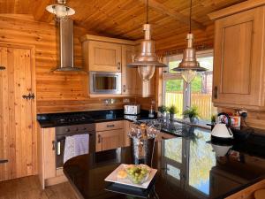 a kitchen with wooden cabinets and a counter top at Stags Head Lodge in Felton +11 photos