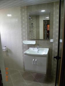 a bathroom with a sink and a mirror at Ваканционно селище Ива in Sarnitsa +198 photos