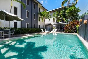 a swimming pool in front of a building at Zion Escapes Cairns City Waters Edge Family Apartment in Cairns