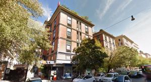 a tall building with cars parked in front of it at Orange Hotel in Rome