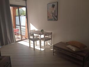 a living room with a table and a chair at Magnifique Studio bord de mer numéro 88 in Santa-Lucia-di-Moriani