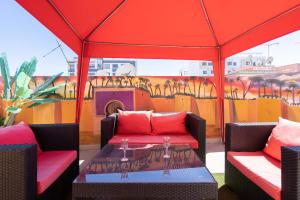 a patio with two chairs and a table in a tent at Terrasses de Marrakech- Au coeur de Casablanca in Casablanca