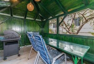 a kitchen with a table and chairs in a shed at Apartment Marigold in Sveti Filip i Jakov