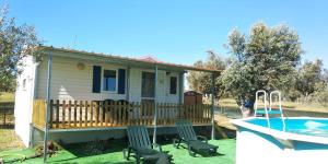 a house with a deck and a swimming pool at Lodge das Taipas in Santo Amaro