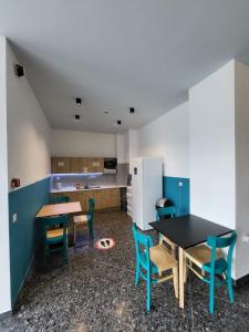 a kitchen with a table and chairs and a refrigerator at Central Hostel in Athens