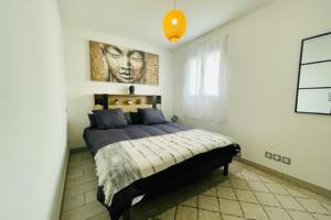 um quarto com uma cama com um quadro na parede em A charming house in Puilboreau em Puilboreau