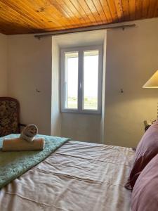 a bedroom with a bed with a towel on it at La Ferme l'Etang in Vachères