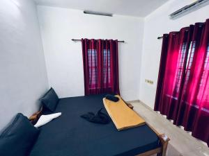 A bed or beds in a room at SAND BEACH HOUSE VARKALA