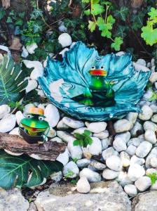a statue of two frogs sitting on a pile of rocks at Hotel Virginia in Garda
