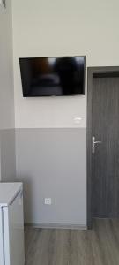 a flat screen tv on a wall next to a door at Air Tel Home in Radom