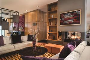 a living room with a couch and a fireplace at Adina Apartment Hotel Copenhagen in Copenhagen