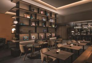 a restaurant with tables and chairs in a room at Adina Apartment Hotel Frankfurt Westend in Frankfurt/Main