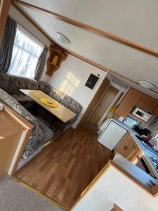 an overhead view of a living room and kitchen in a tiny house at the Samanda Van Newport caravan park in Hemsby
