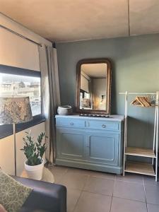a room with a blue dresser with a mirror at Le Saint Roch 2 - AC CLIM - WIFI - 50m Centre ville in Avignon