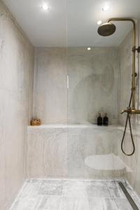 a shower with a glass door in a bathroom at Villa Rustica in Agios Gordios