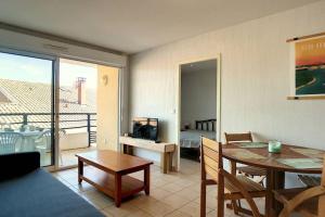 ein Wohnzimmer mit Tisch und ein Esszimmer in der Unterkunft V-Mimosas 01-Vieux Boucau Appartement 6 personnes calme au cœur de Vieux Boucau proche skatepark in Vieux-Boucau-les-Bains