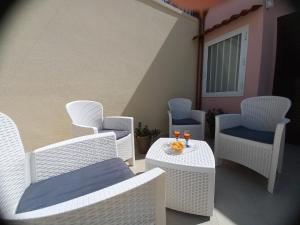 un grupo de sillas y mesas en un patio en La vie en rose, en Mola di Bari