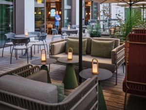a restaurant with tables and chairs and candles at Adina Apartment Hotel Cologne in Cologne