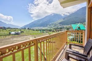 a balcony with a view of the mountains at Thrill Nature Cottage in Manāli