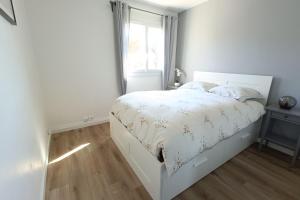 a white bed in a bedroom with a window at Spacious and bright cocoon near the sea in Bandol +7 photos