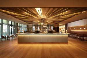 a restaurant with a bar with tables and chairs at Adina Apartment Hotel Dusseldorf in Düsseldorf