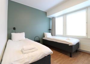 Postel nebo postele na pokoji v ubytování Forenom Aparthotel Helsinki Herttoniemi