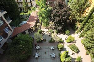 an overhead view of a courtyard with tables and trees at Adina Apartment Hotel Budapest in Budapest