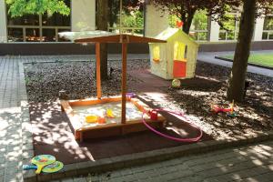 a childs play area with a sandbox and a house at Adina Apartment Hotel Budapest in Budapest