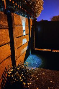 a door to a building with a fence at night at Rensch Place in Bloemfontein