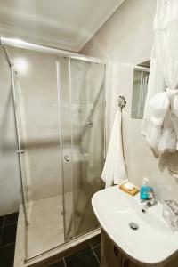 a bathroom with a shower and a sink at Rensch Place in Bloemfontein