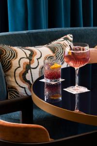 a table with two glasses of drinks on a table at Hotel Montalembert in Paris