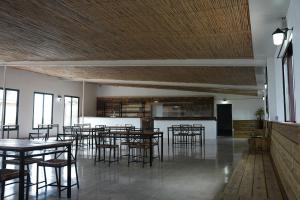a dining room with tables and chairs in a building at La Finestra del Delta in L'Ampolla